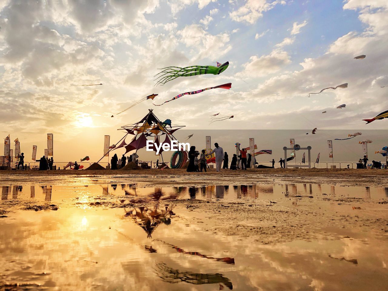 PEOPLE ON BEACH AGAINST SKY