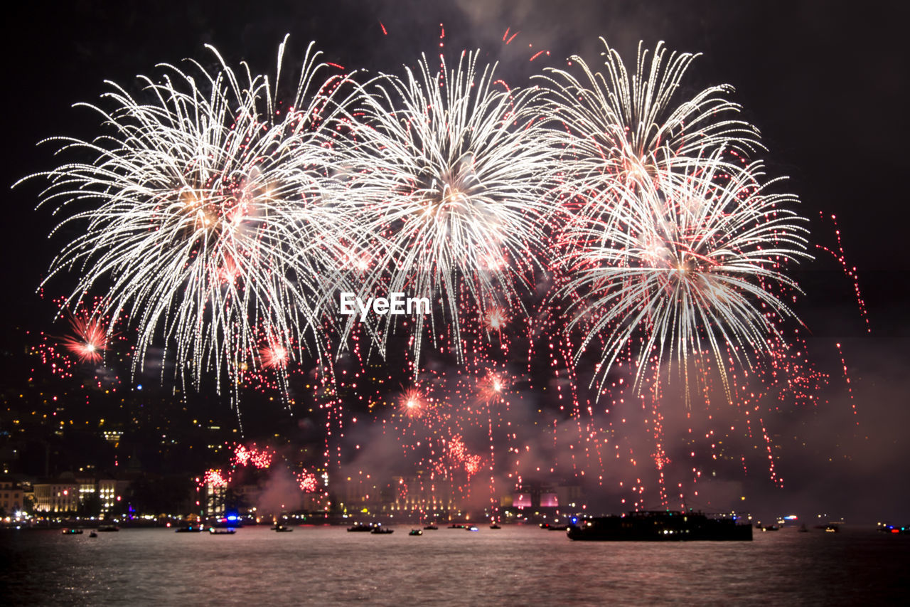 Low angle view of firework display at night