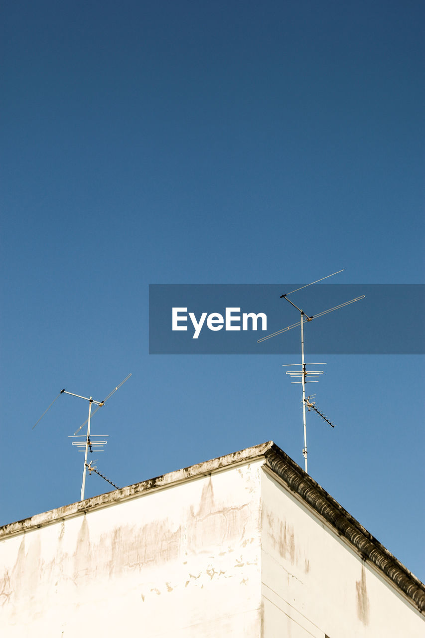 Low angle view of building against clear blue sky