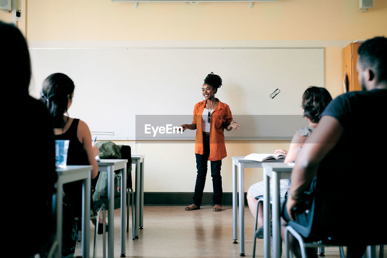 Teacher teaching language to students in classroom