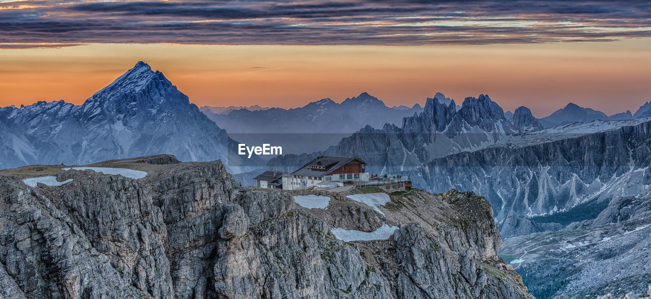 SCENIC VIEW OF SNOWCAPPED MOUNTAIN DURING SUNSET