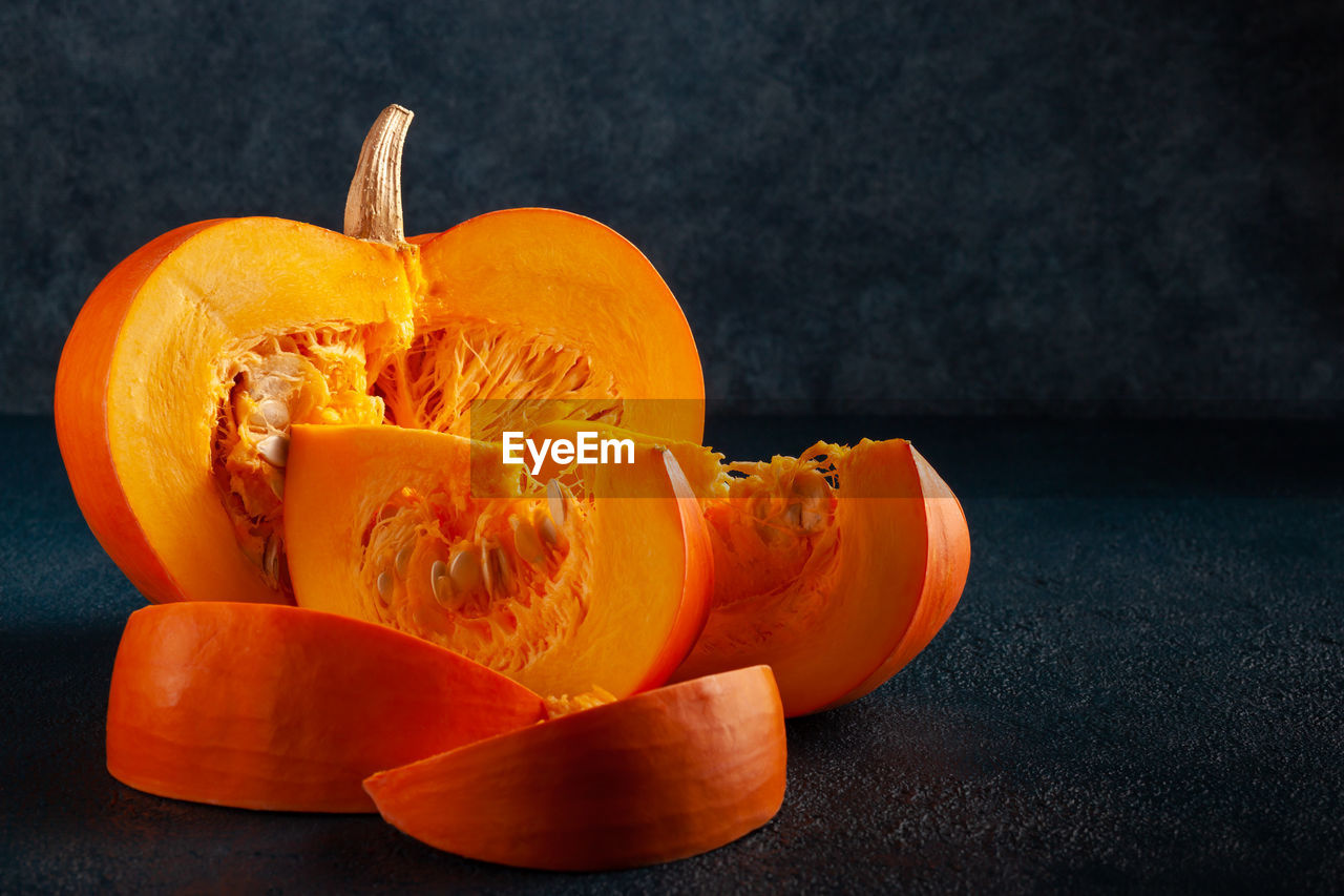 food and drink, food, orange color, healthy eating, yellow, orange, pumpkin, wellbeing, still life photography, produce, vegetable, halloween, freshness, indoors, studio shot, fruit, no people, still life, celebration, winter squash, squash, slice, macro photography, black background, creativity, citrus fruit