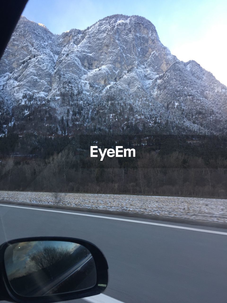 Close-up of car on road against mountain range