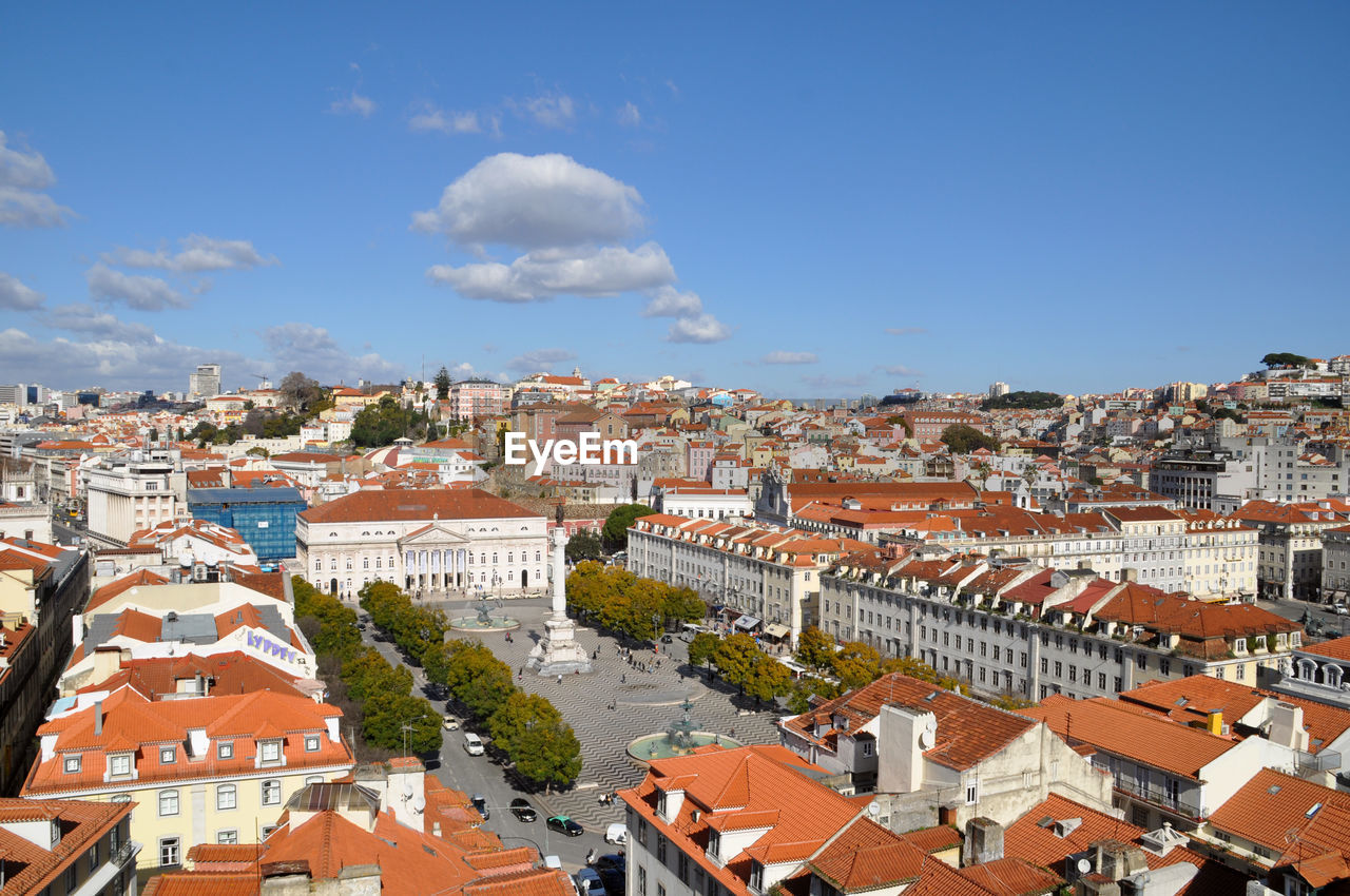 View of cityscape against cloudy sky