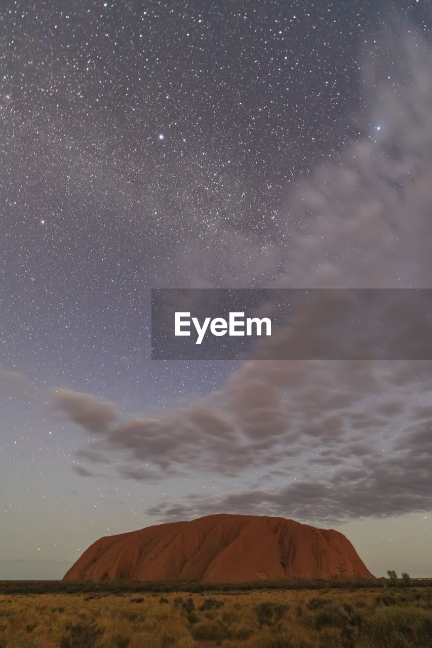 Australia, northern territory, starry sky over uluru (ayers rock) at dusk