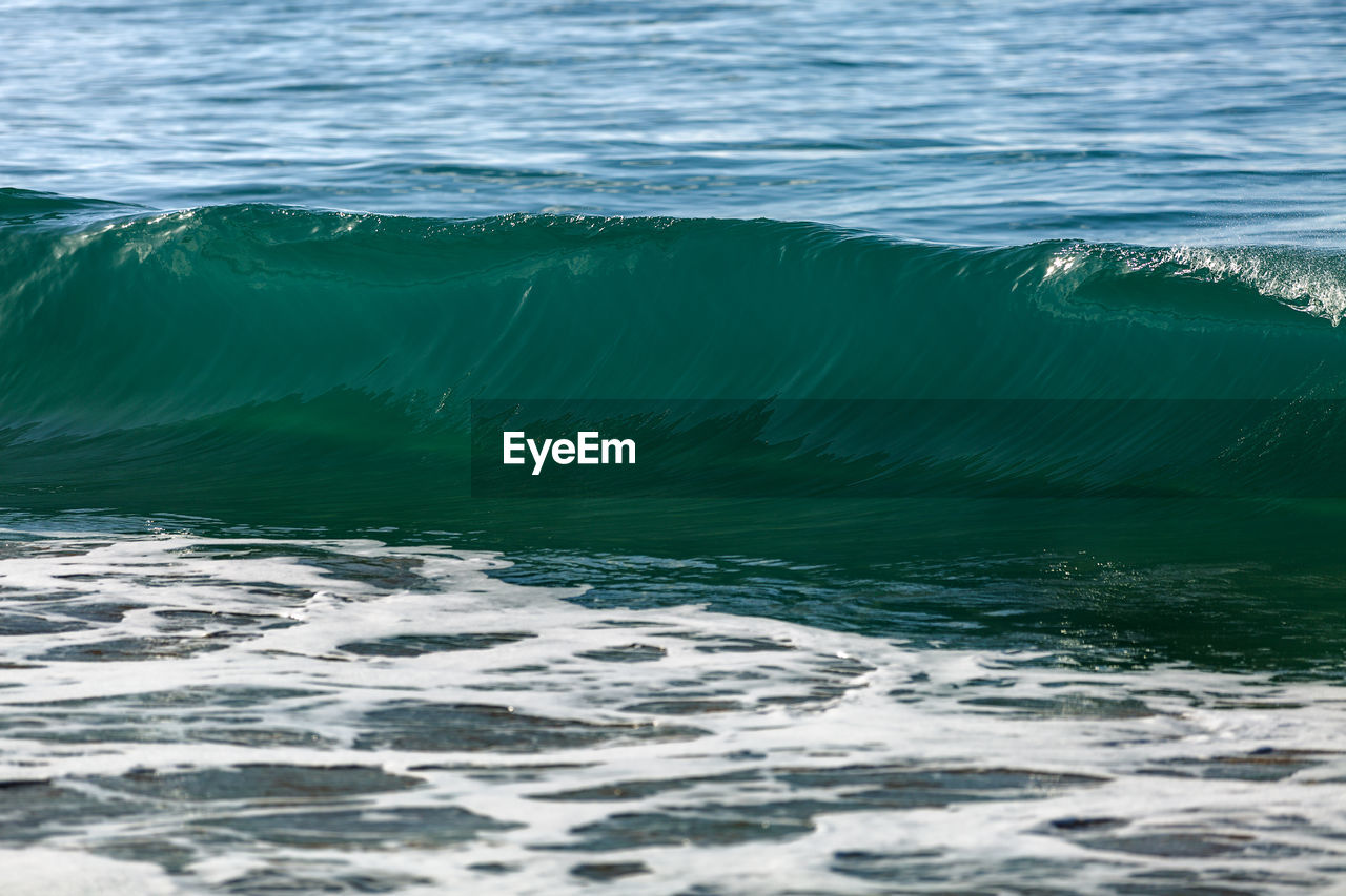 SCENIC VIEW OF SEA WAVES RUSHING TOWARDS SHORE