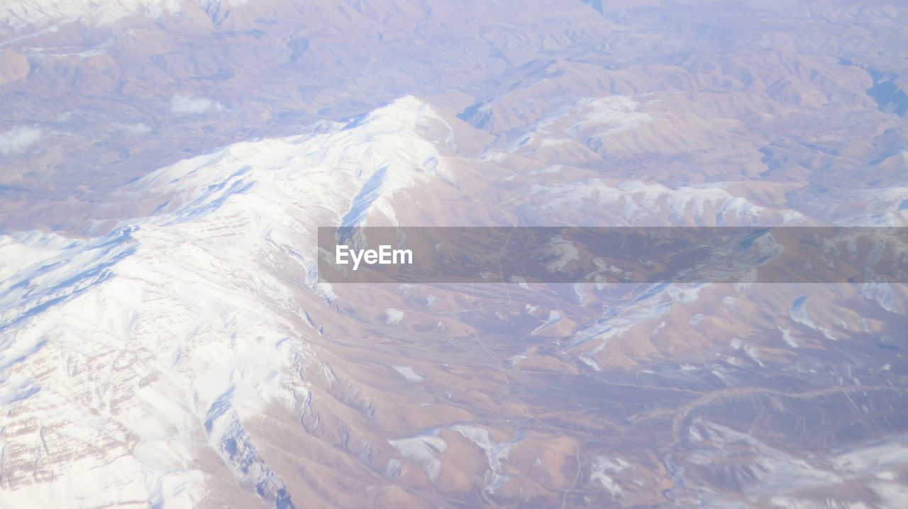 AERIAL VIEW OF SNOWCAPPED MOUNTAIN