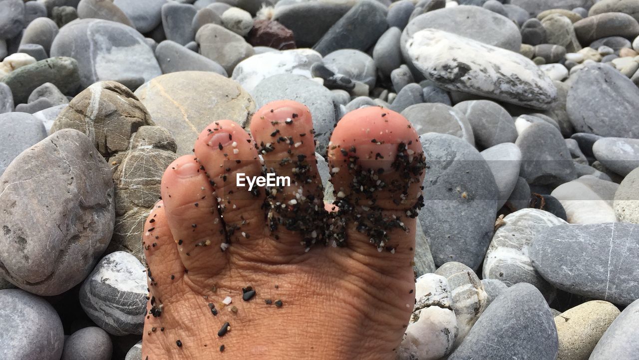 LOW SECTION OF PERSON ON ROCKS