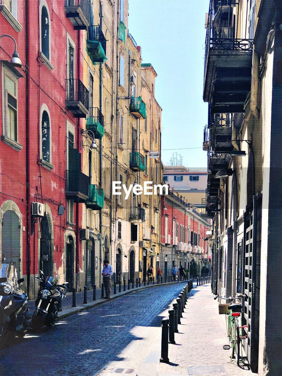 STREET AMIDST BUILDINGS AGAINST SKY