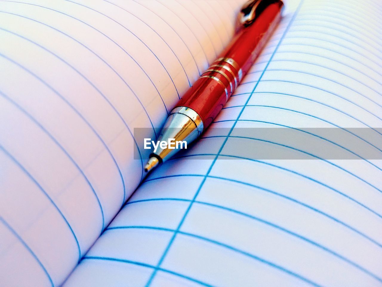Close-up of pen on blank book