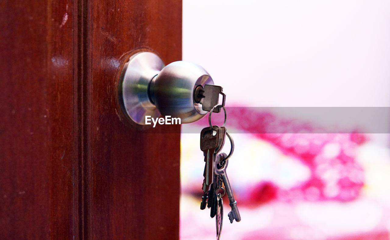 Close-up of keys hanging from door