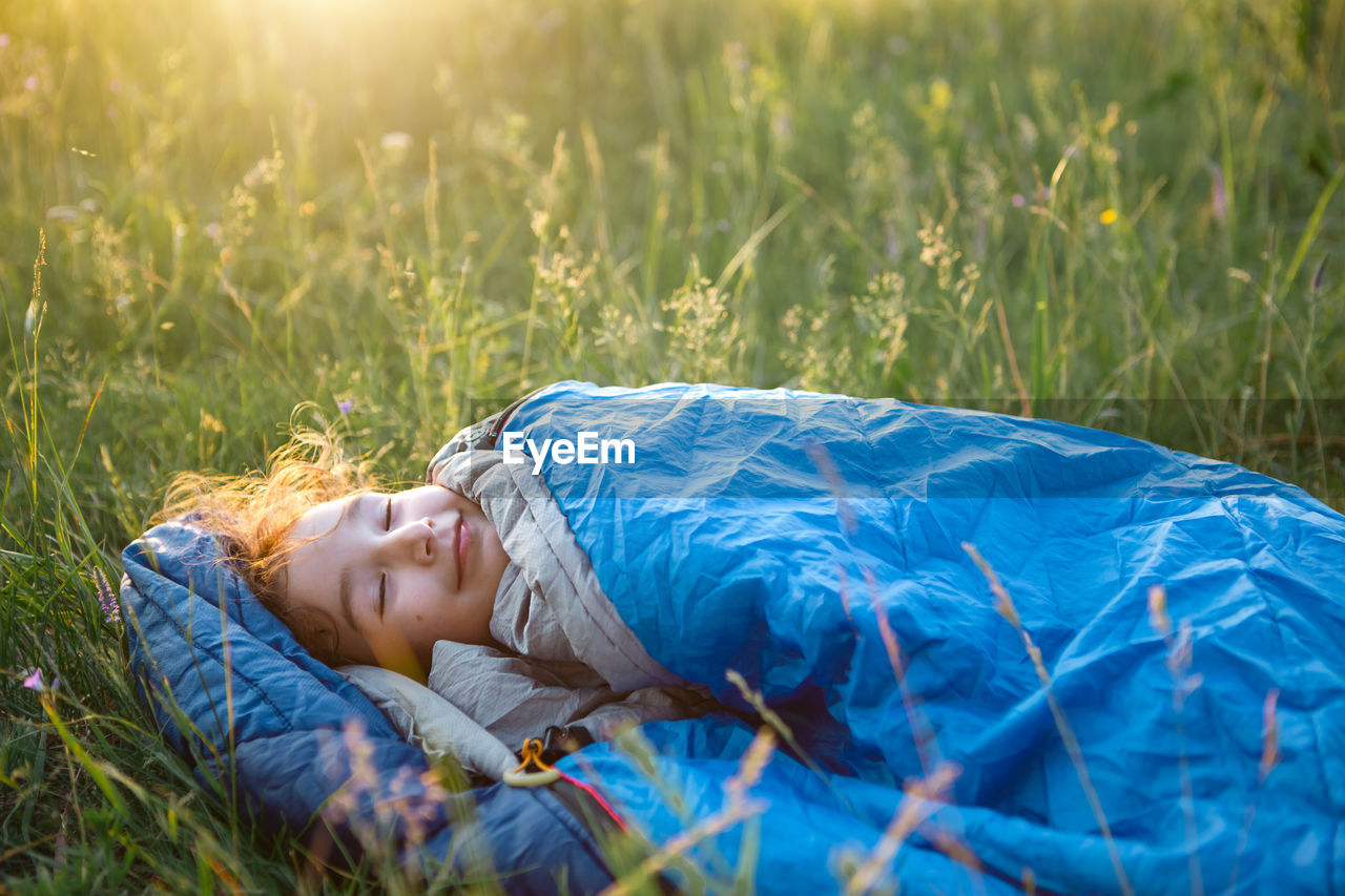 Cute girl lying on grass at park