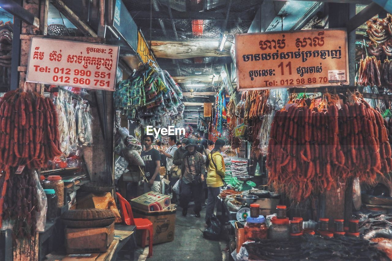 CLOTHES HANGING FOR SALE AT MARKET STALL IN STREET