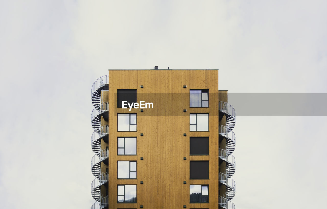 Modern residential building with wood cladding and spiral emergency stairs. lillehammer, norway. 