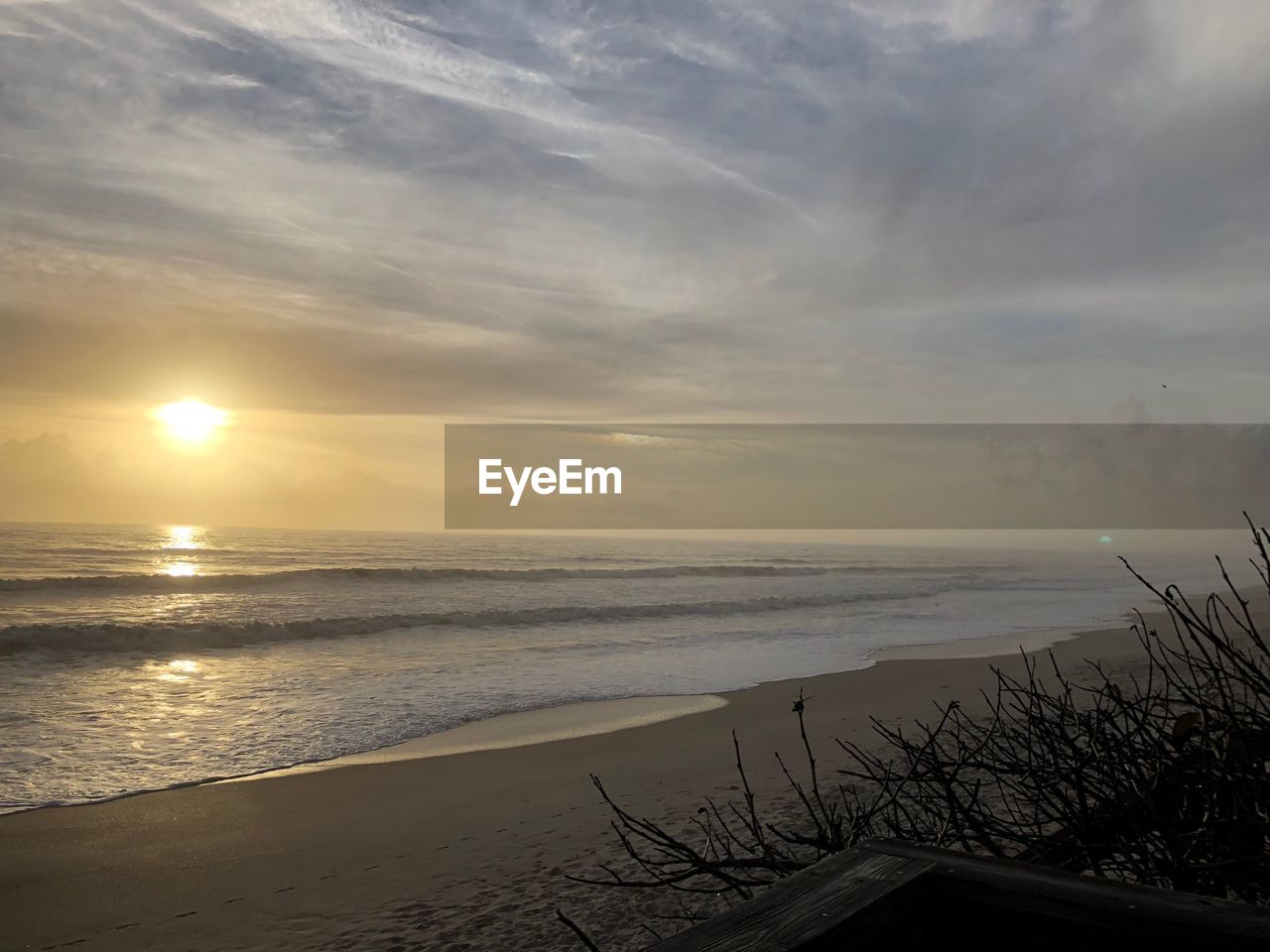 SCENIC VIEW OF BEACH AGAINST SKY DURING SUNSET