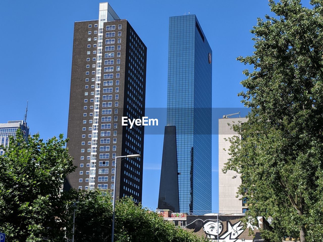 LOW ANGLE VIEW OF BUILDINGS AGAINST BLUE SKY