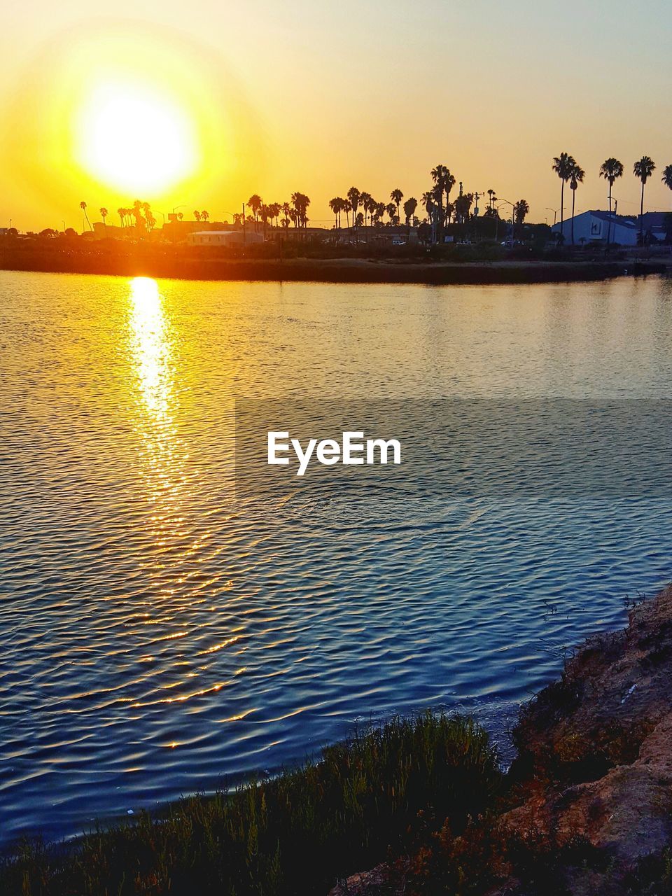 Scenic view of lake against sky during sunset