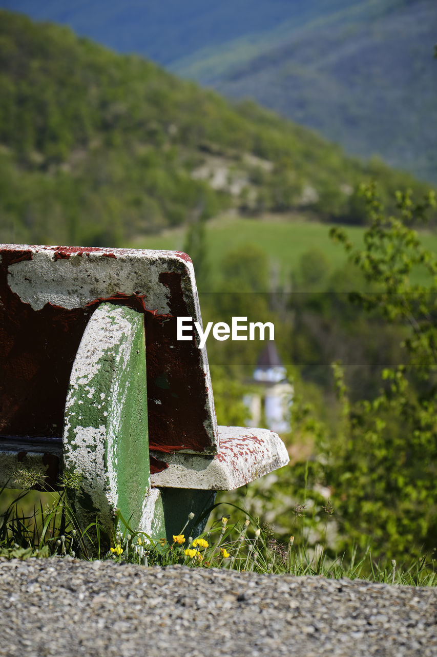 CLOSE-UP OF OLD TRUCK ON LAND