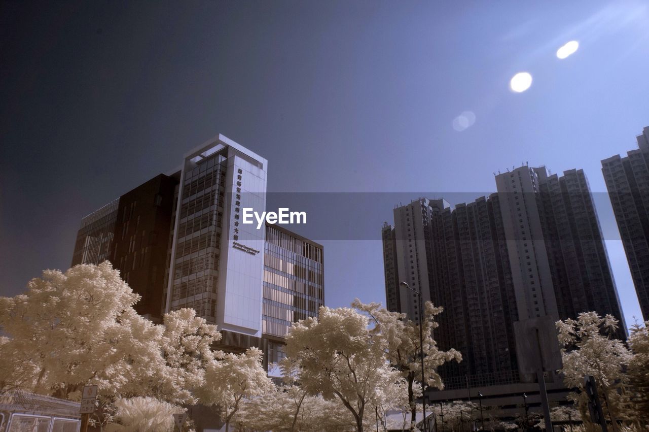 Low angle view of buildings against clear blue sky