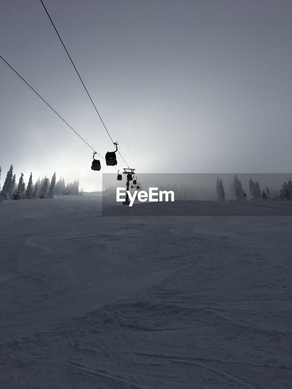 OVERHEAD CABLE CAR ON SNOW COVERED LANDSCAPE