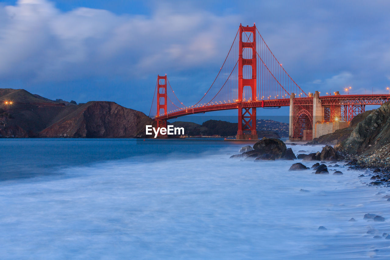 Golden gate bridge over river against sky