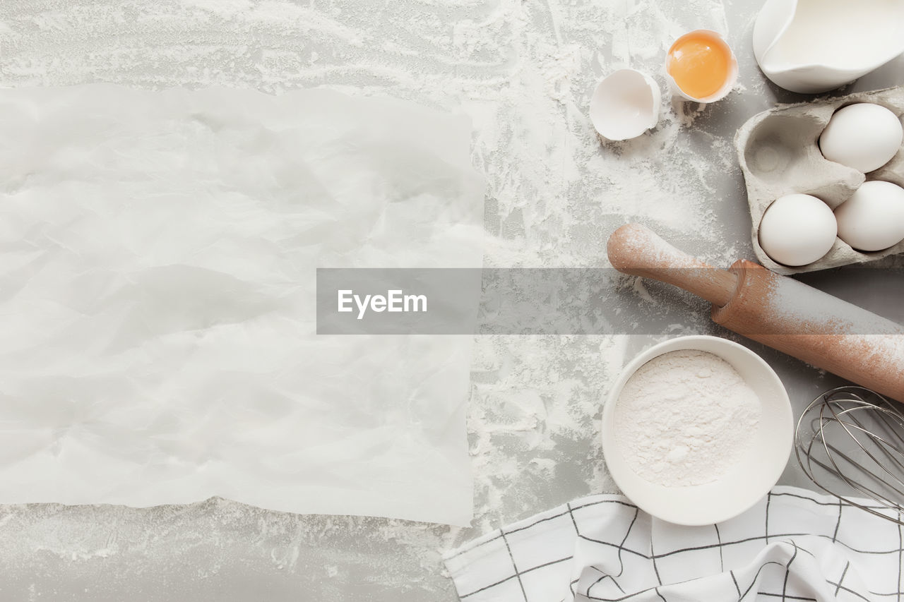 Baking ingredients, kitchen utensils, cooking christmas cookies on grey concrete background flat lay