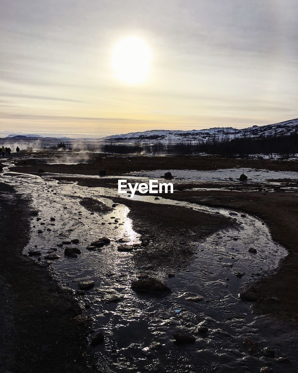 SNOW COVERED LANDSCAPE AGAINST SKY DURING SUNSET