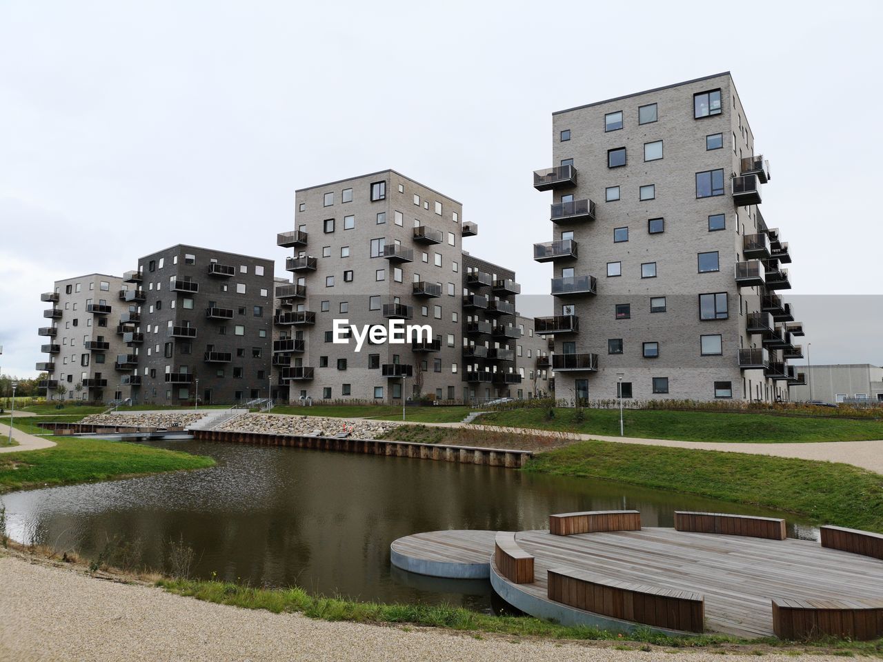 Canal amidst buildings against sky in city