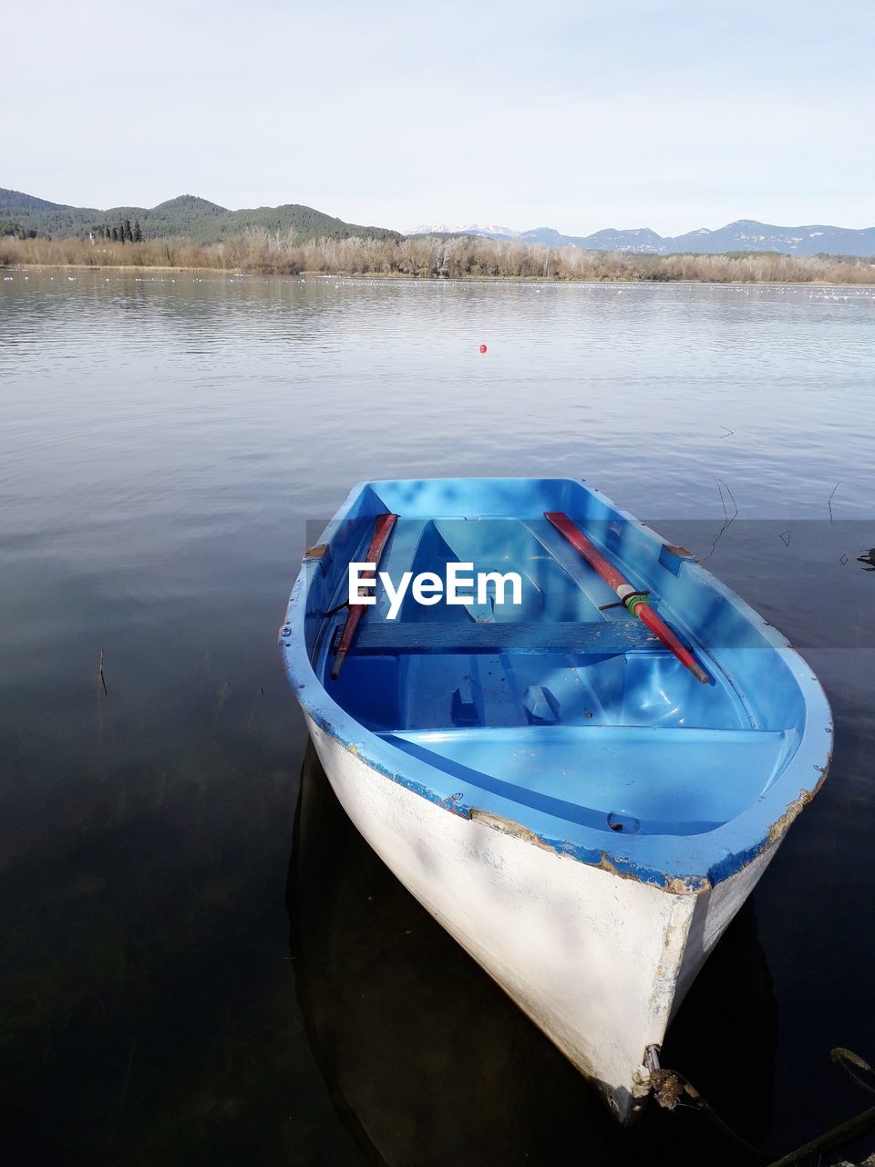 BOAT MOORED IN LAKE