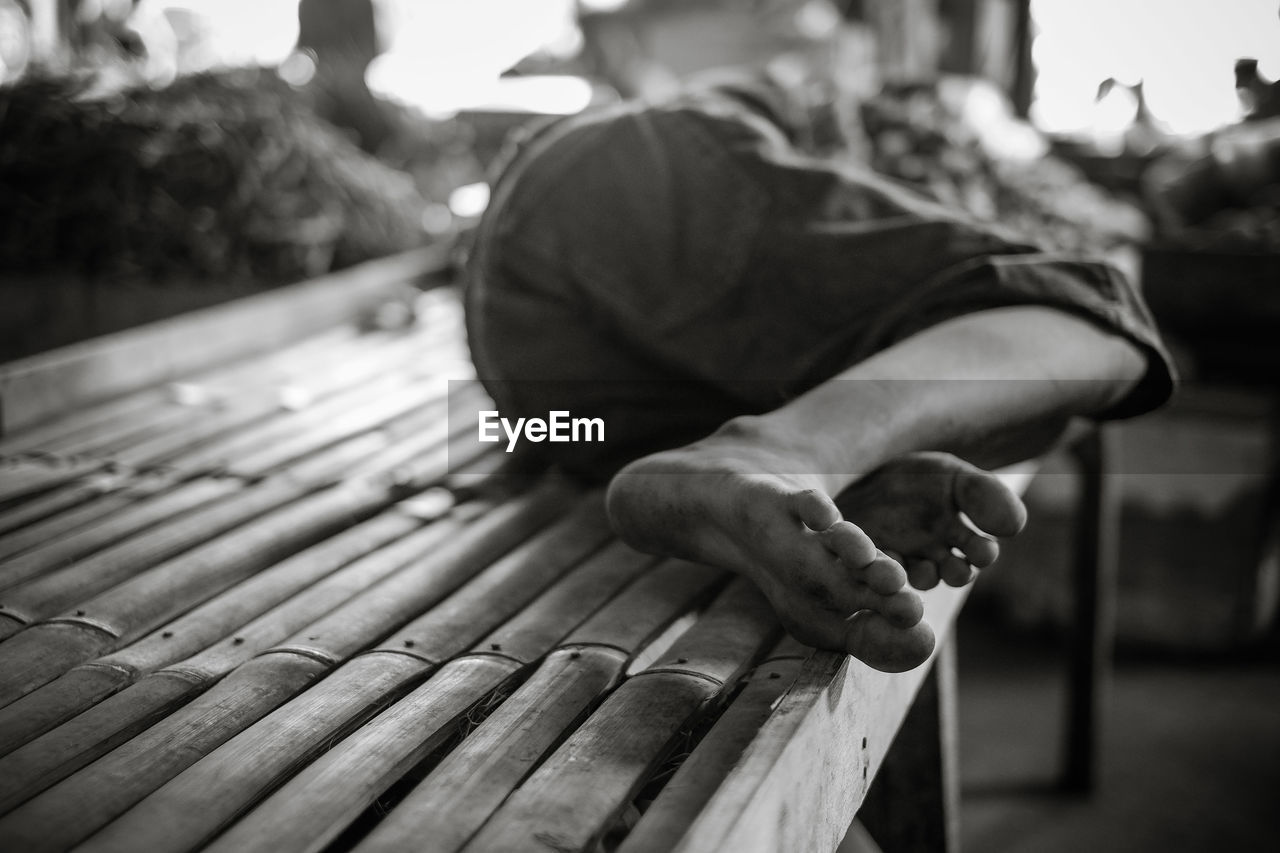 Man lying on bench