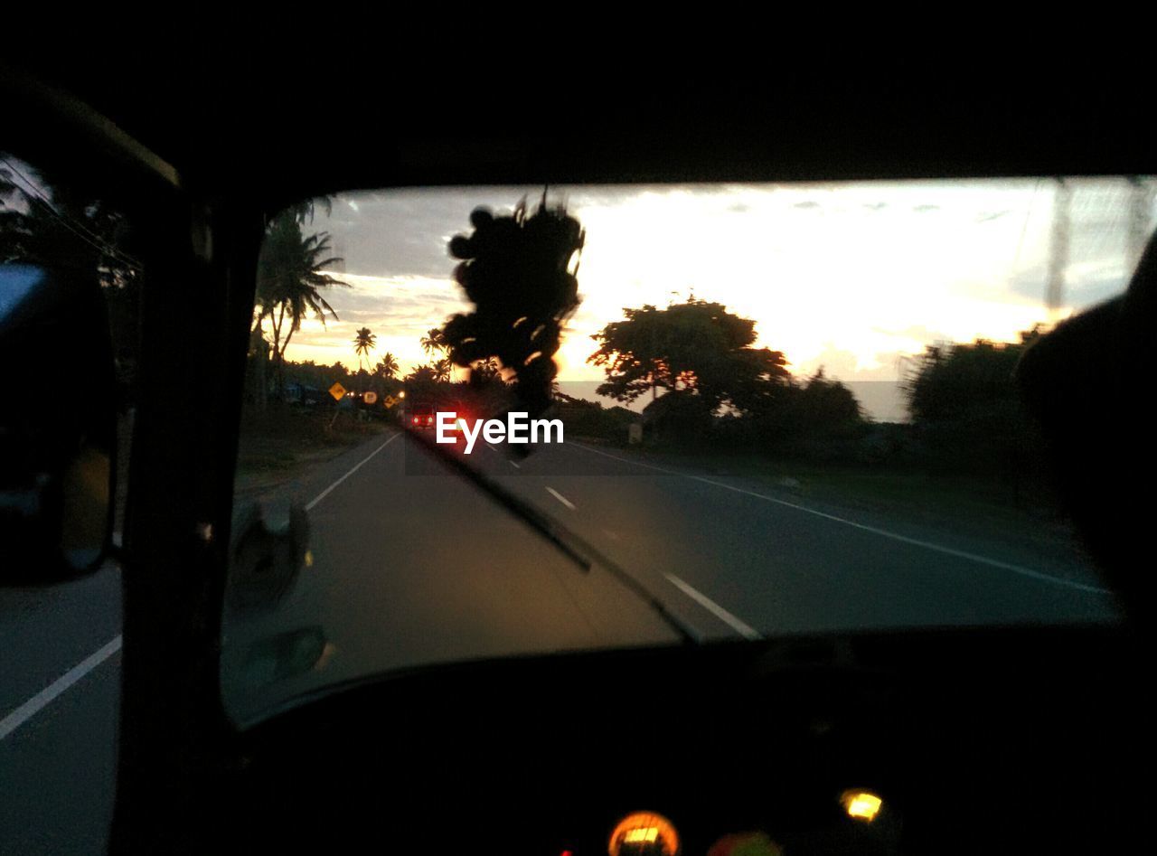 SUNSET SEEN THROUGH TRAIN WINDSHIELD