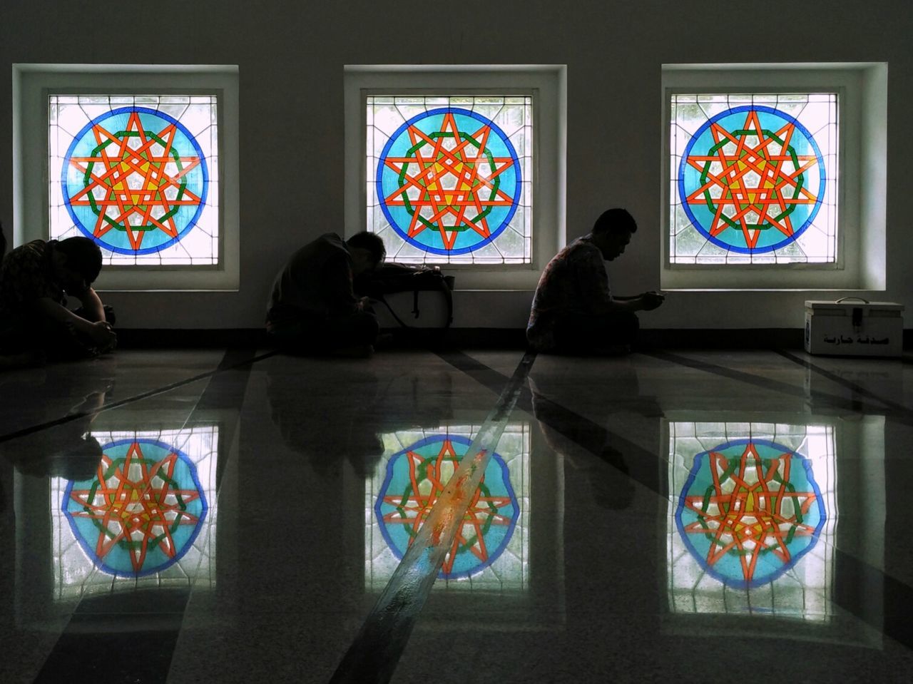 REAR VIEW OF PEOPLE LOOKING AT ENTRANCE OF AN