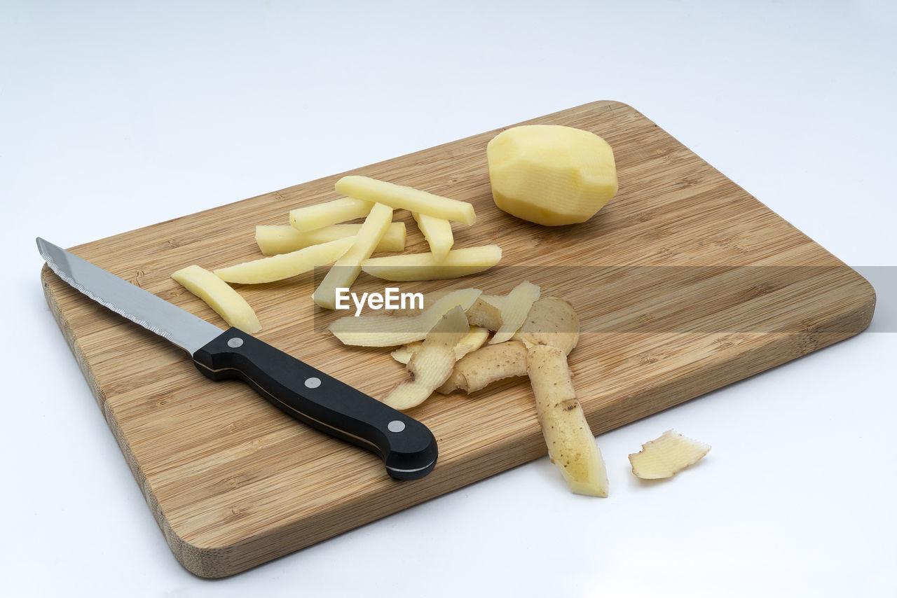 Cutting  potatoes on a wooden tablet