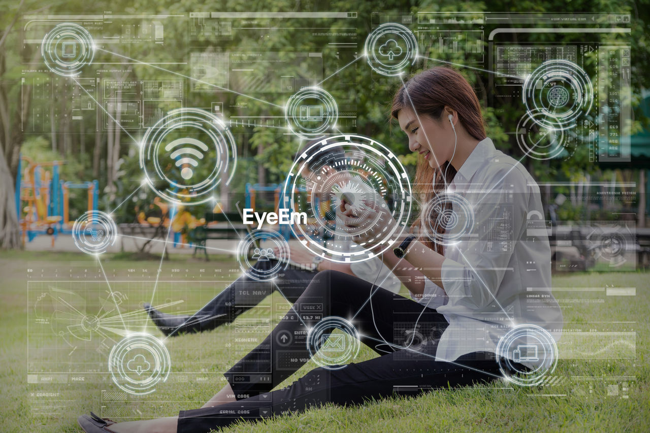 one person, adult, women, full length, young adult, sitting, casual clothing, creativity, grass, nature, technology, day, plant, child, female, looking, circle, outdoors, childhood, geometric shape, holding, player