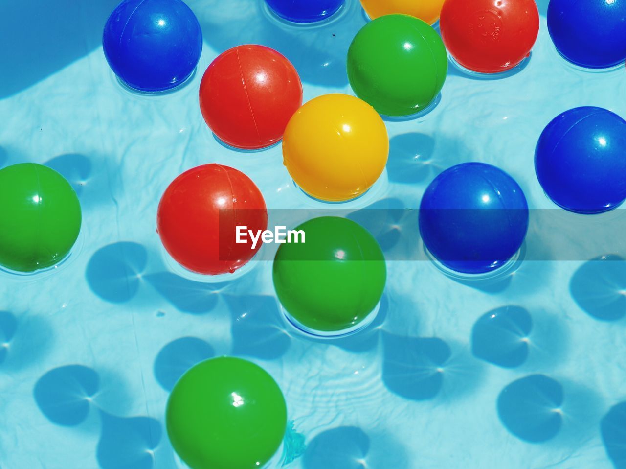 High angle view of colorful balls floating on swimming pool