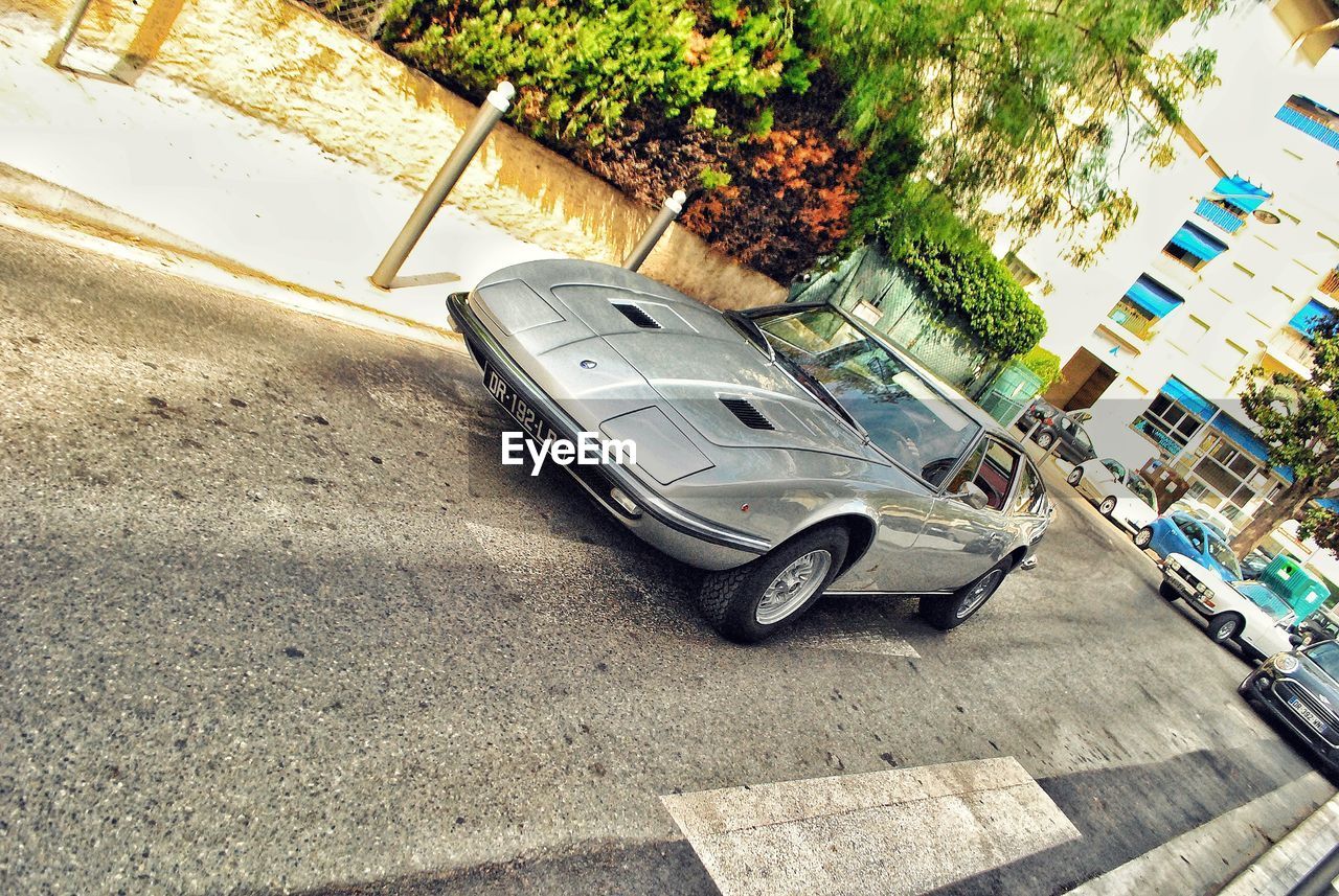 HIGH ANGLE VIEW OF CAR PARKED ON ROAD