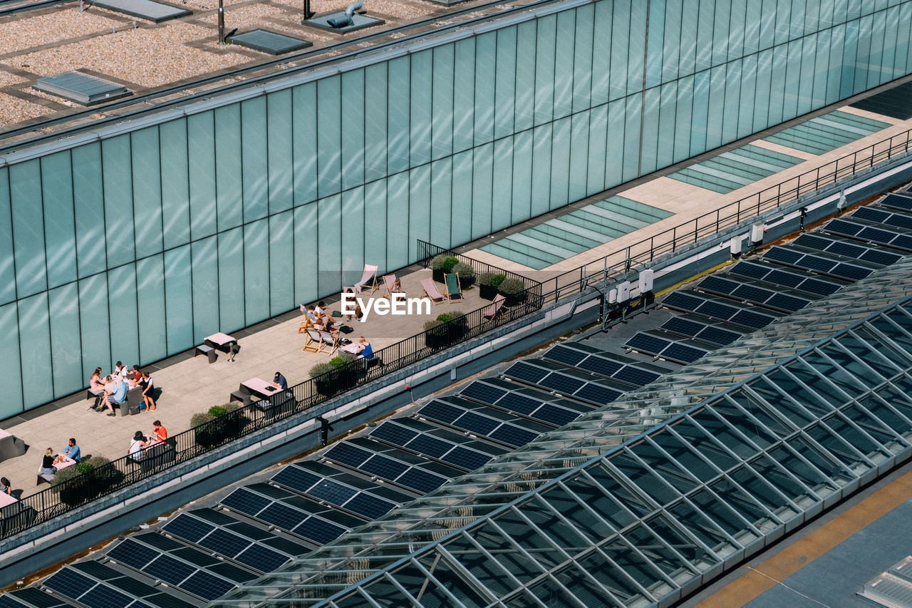 High angle view of people on street in city during sunny day