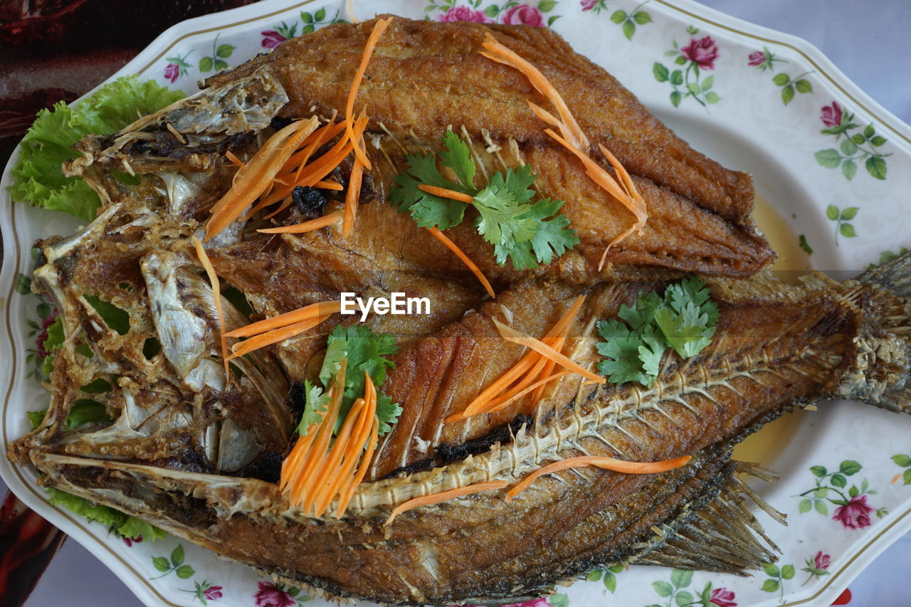 High angle view of fish in plate on table