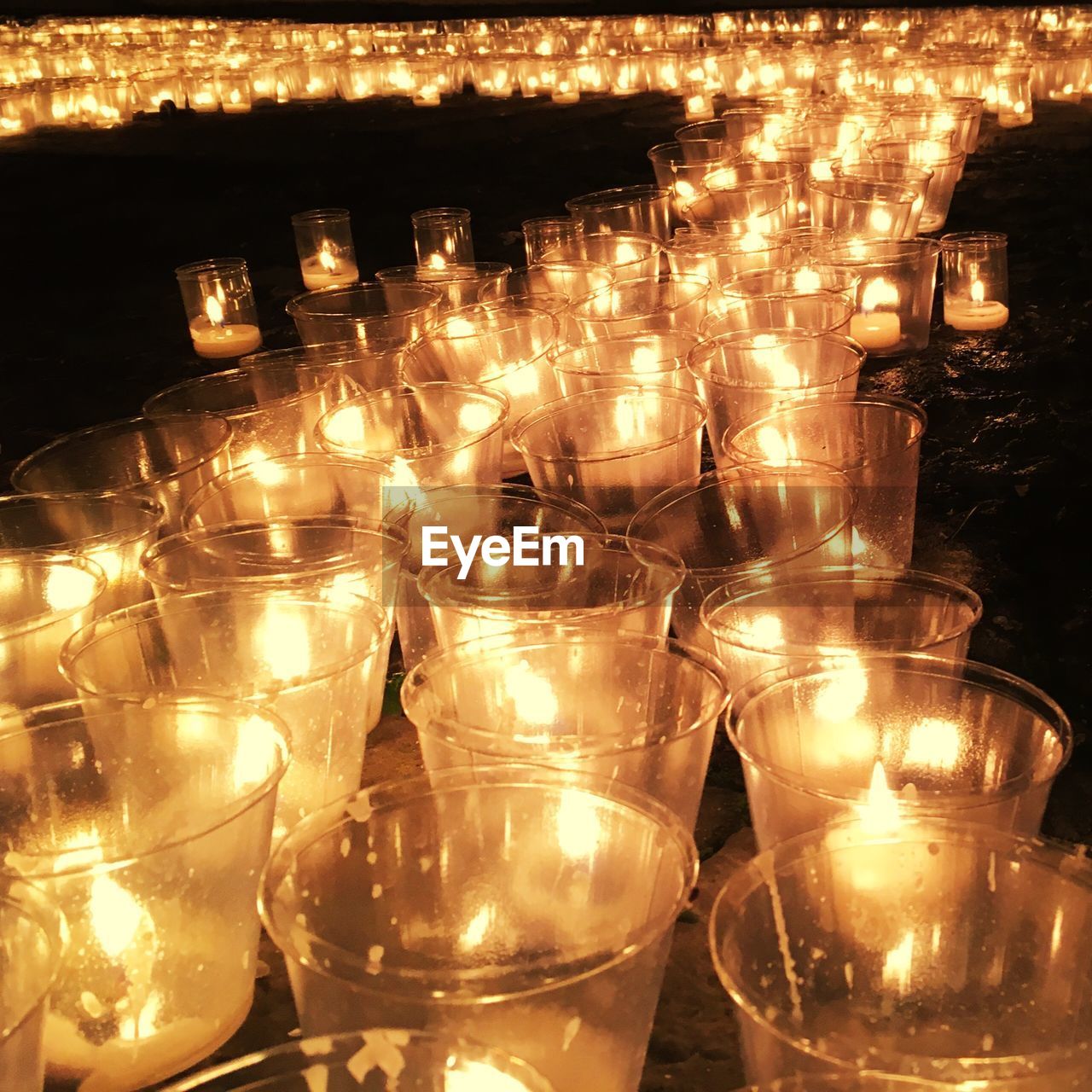 Illuminated lit tea lights at night