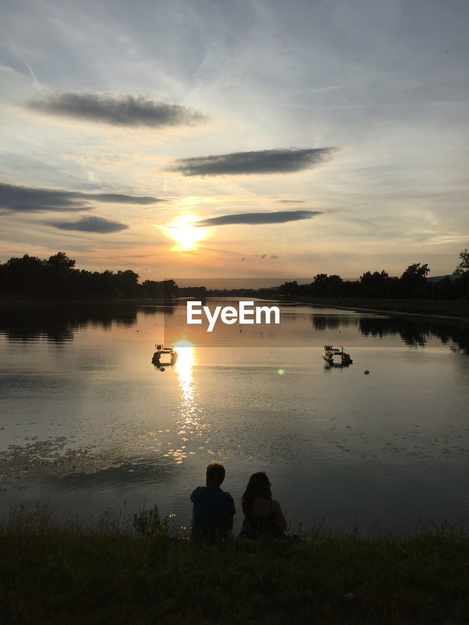 Scenic view of lake against sky during sunset