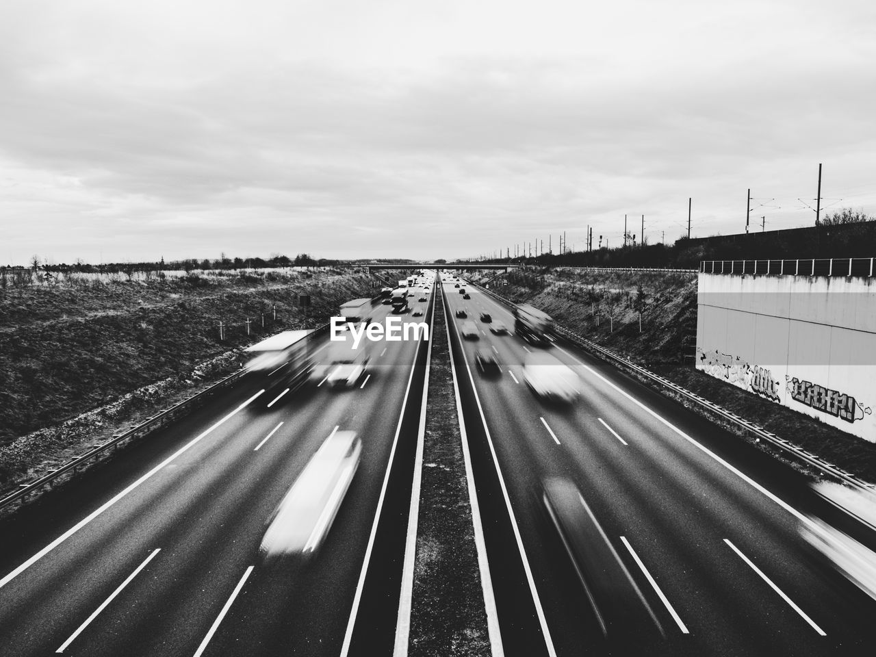 BLURRED MOTION OF HIGHWAY ON ROAD AGAINST SKY