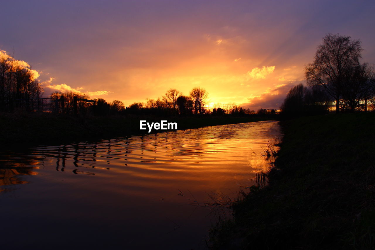 Scenic view of lake at sunset