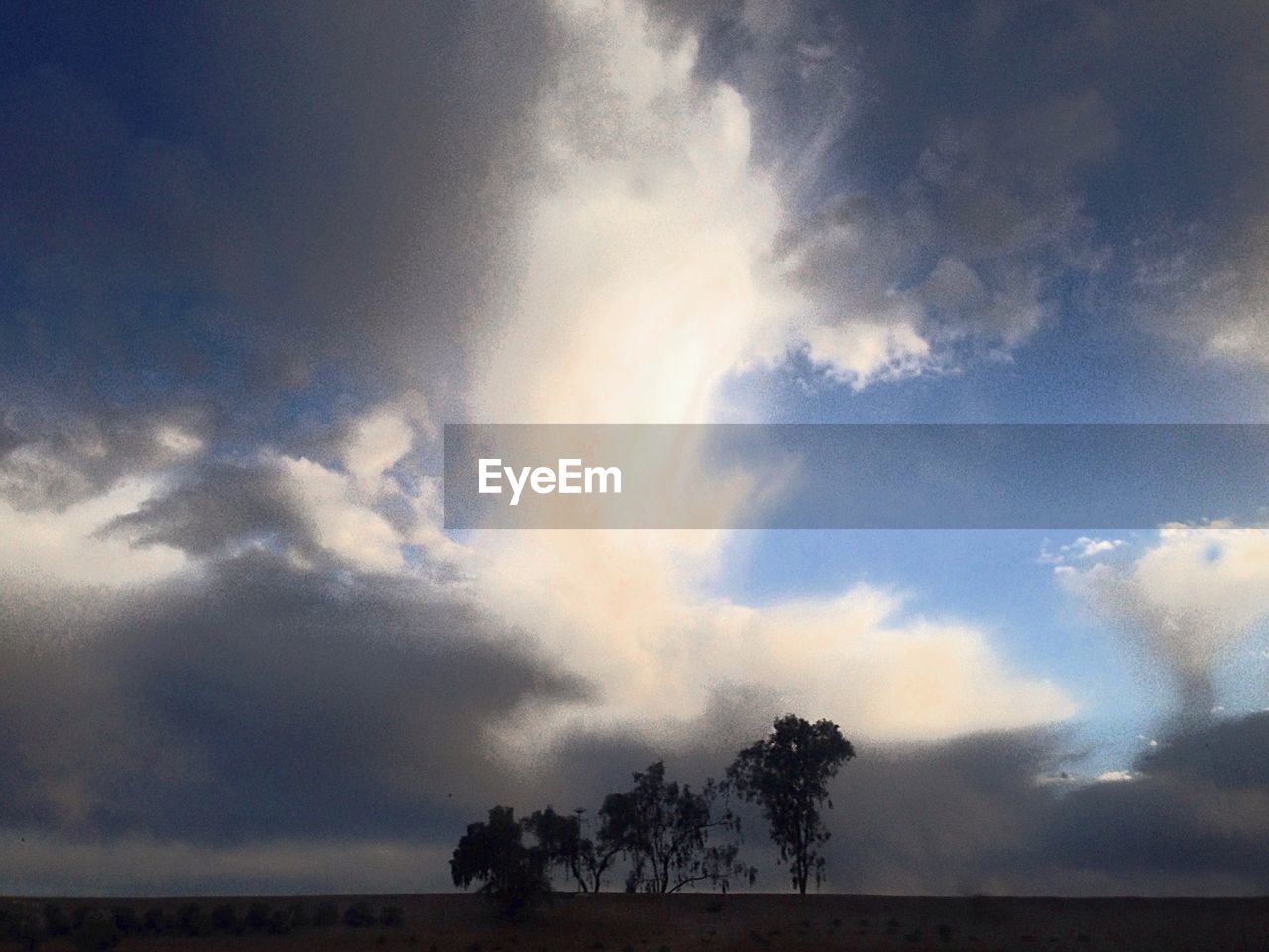 SCENIC VIEW OF CLOUDY SKY OVER TREES