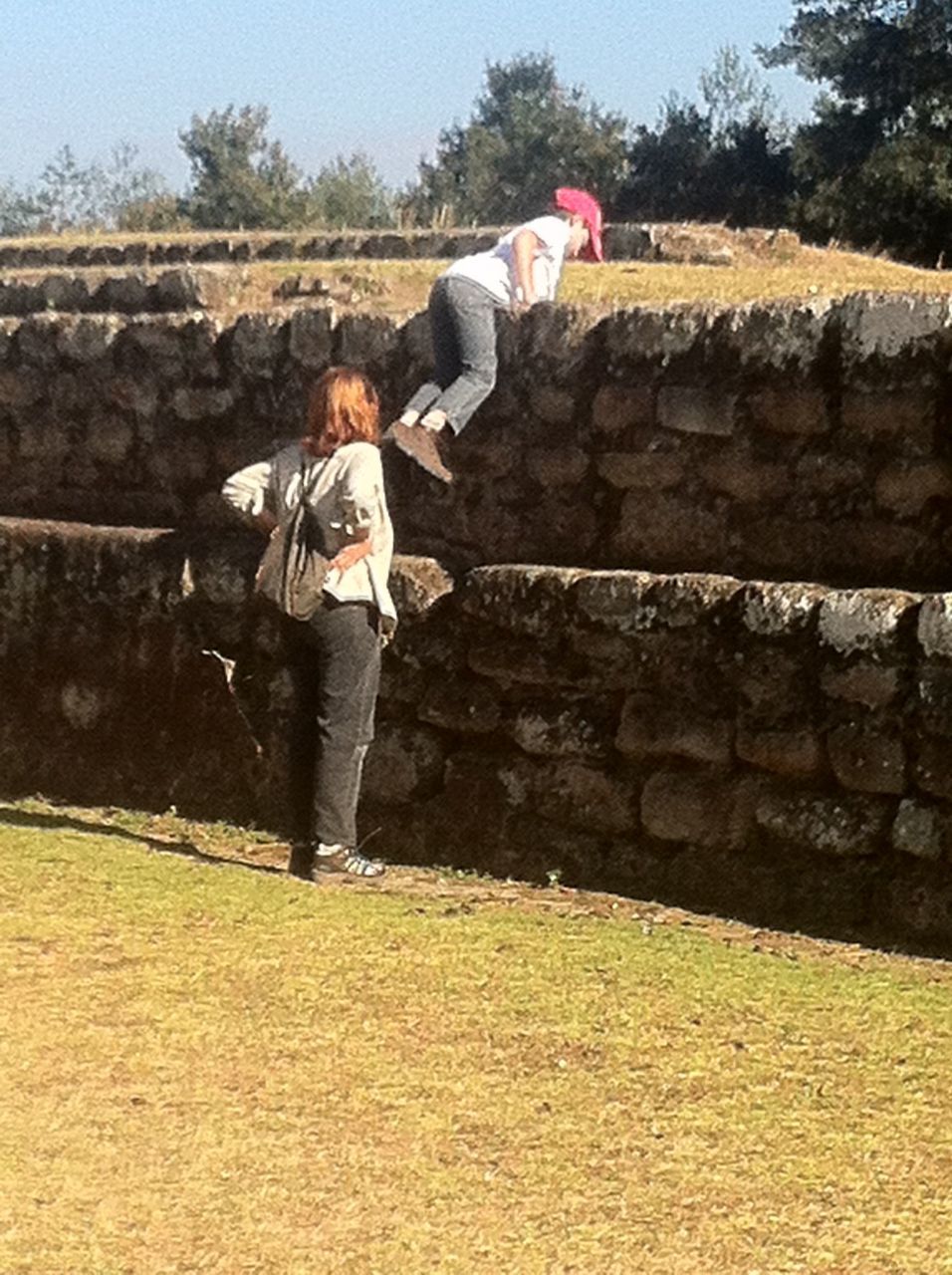 FULL LENGTH OF BOY STANDING ON STONE WALL