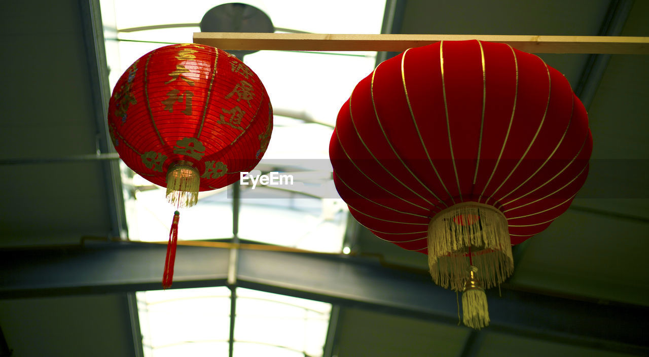 Low angle view of illuminated lanterns hanging from ceiling