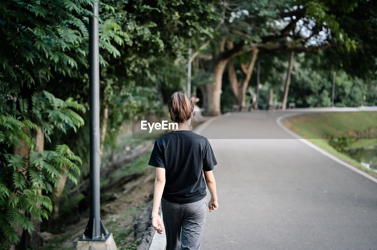 Rear view point of young woman walking on the way , hope and dream concept