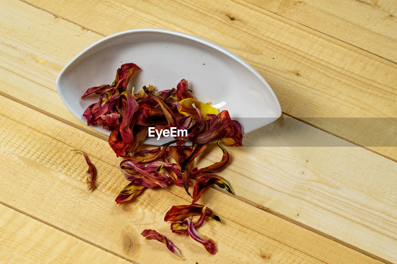 food and drink, food, wellbeing, freshness, produce, wood, healthy eating, indoors, table, high angle view, plant, dried food, no people, spice, still life, petal, dry, flower, ingredient, red, vegetable, nature, leaf, close-up