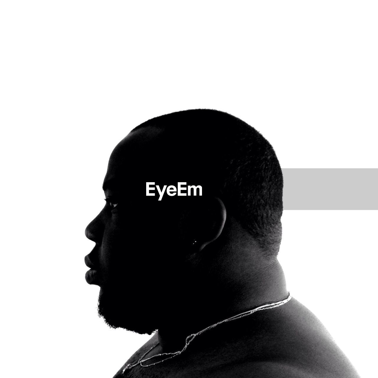 Side view of mid adult man against white background