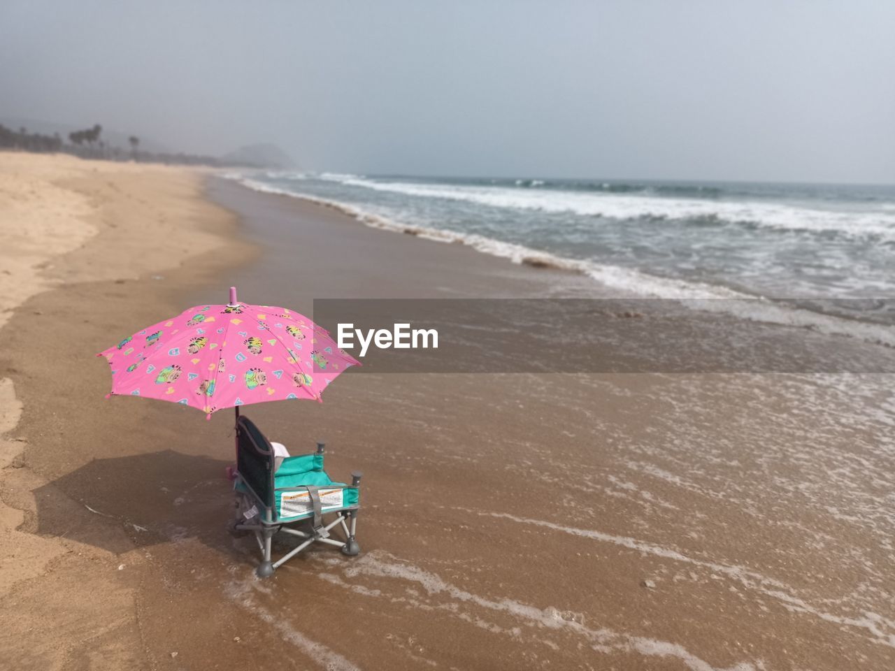 DECK CHAIRS ON SHORE AGAINST SKY