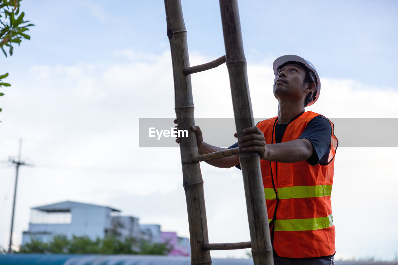 Low angle view of man standing against sky